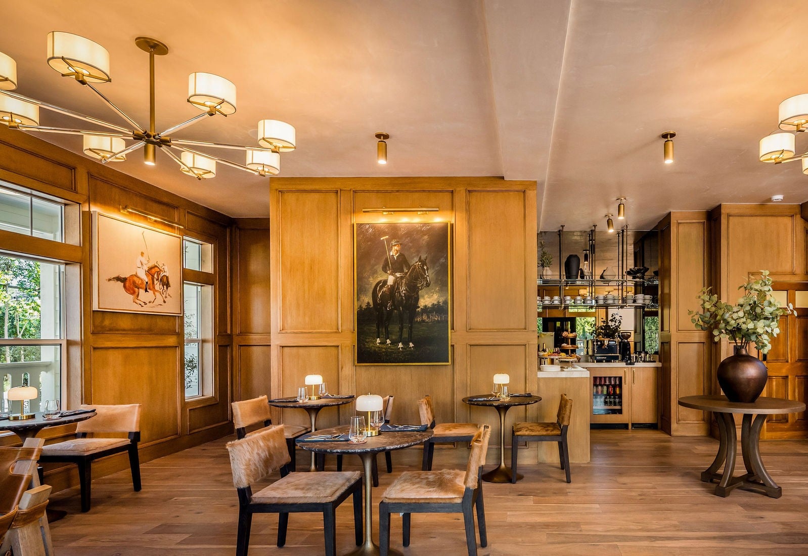 The lobby lounge with equestrian portraits at The Polo House