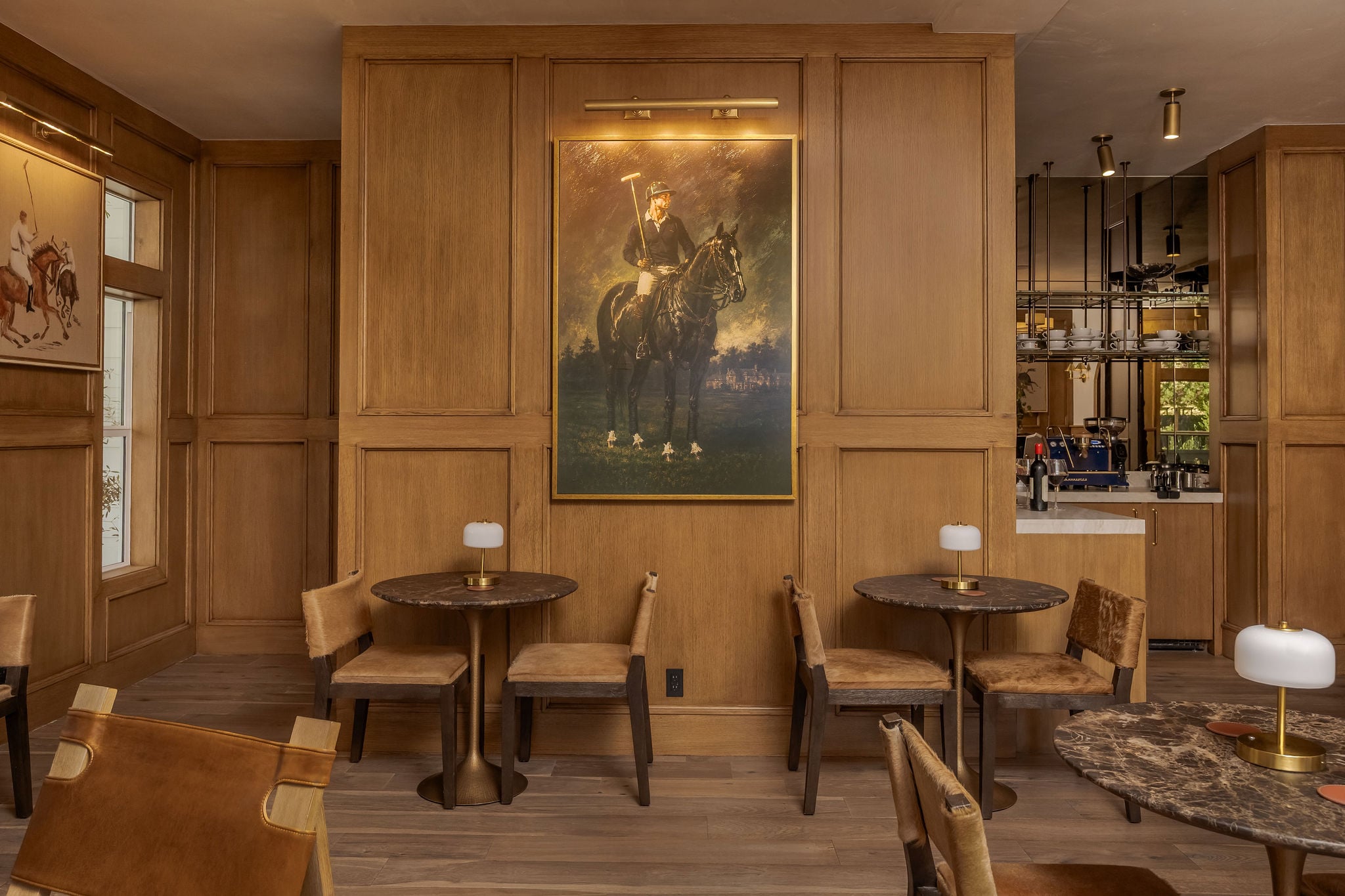 The oak-paneled lobby lounge with a polo portrait at The Polo House